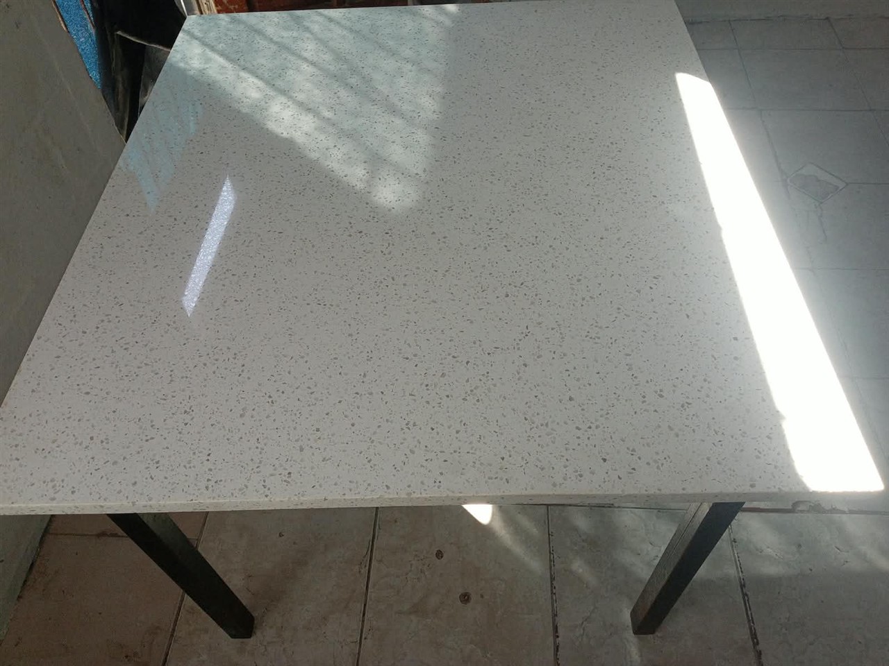 Finished custom stone table top on a black metal base