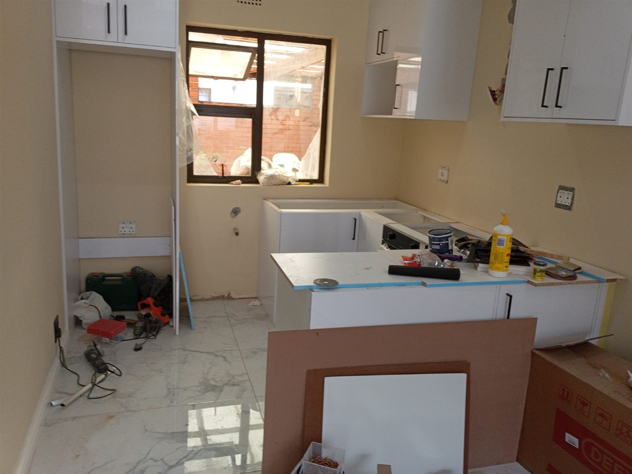 Kitchen before the countertop and waterfall island installation